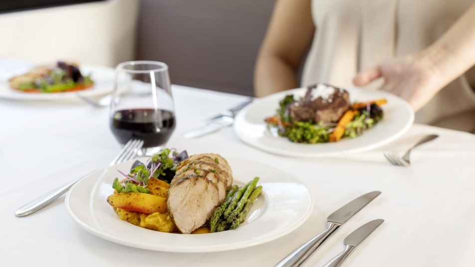 Meals on white linens served with wine