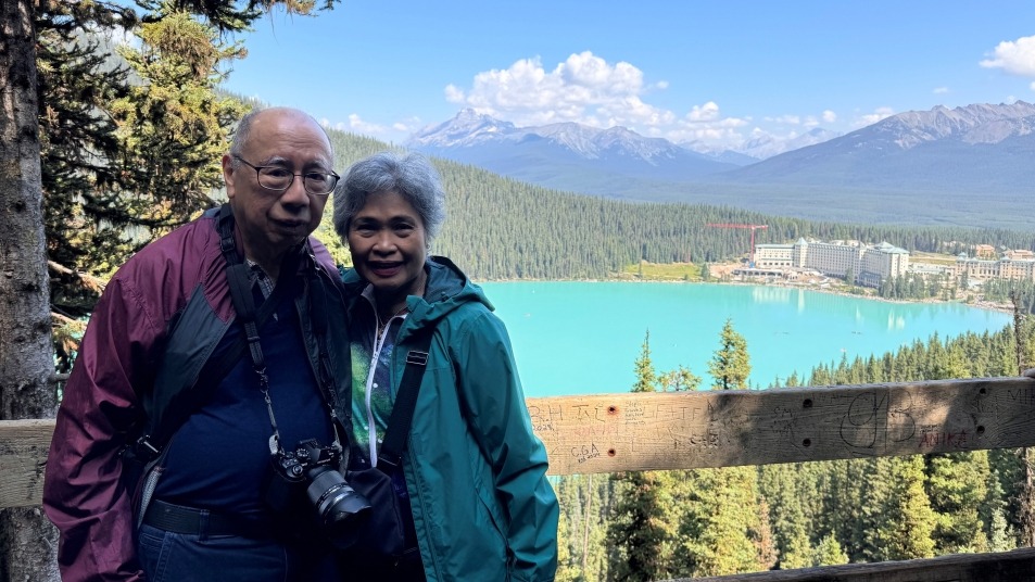 Couple standing in front of Lake Louise.