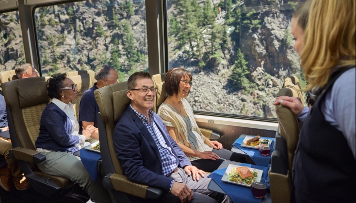 Rocky Mountaineer hosts and guests in SilverLeaf rail car