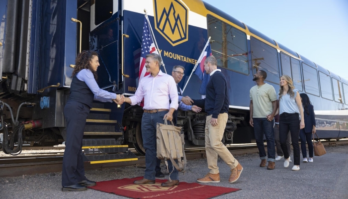 Rocky Mountaineer host welcoming guests onboard the train