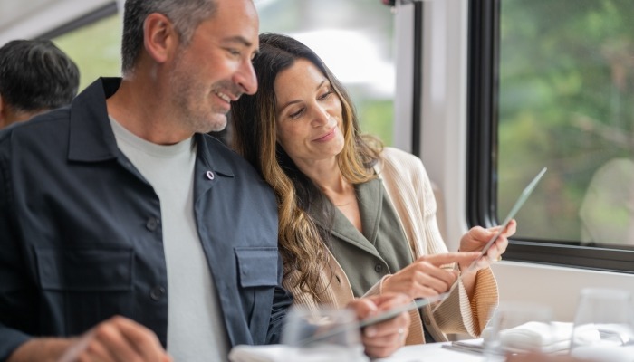 A couple reading the breakfast menu