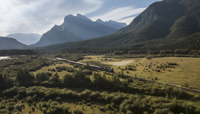 Rocky Mountaineer train travelling past Mount Rundle and Vermilion Lakes, Alberta