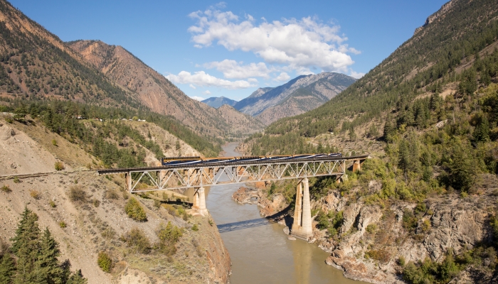 Rocky Mountaineer server carrying Pacific prawns and beef short ribs