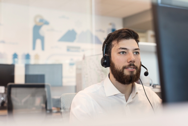 man working at desk with headset