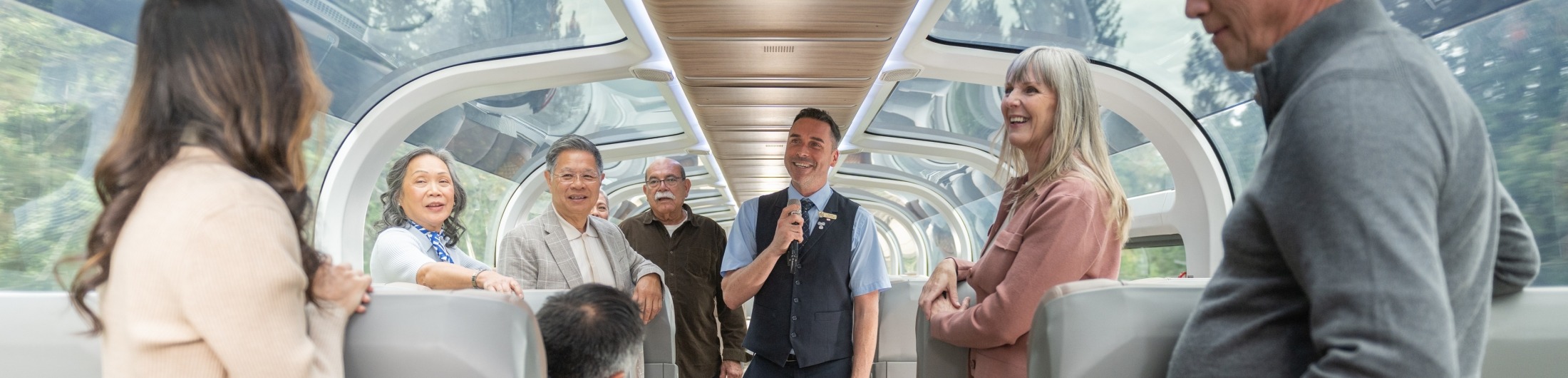 Host giving commentary to guests in GoldLeaf coach
