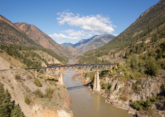 Rocky Mountaineer train travelling over the Fraser River Bridge, British Colombia