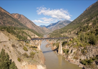 Rocky Mountaineer train travelling over the Fraser River Bridge, British Colombia