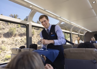 Rockies to the Red Rocks host serving wine to a guest