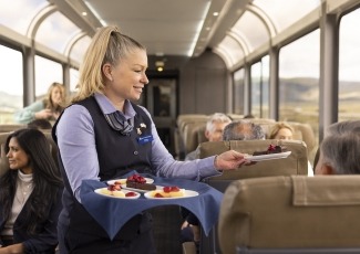 Host serving dessert to guests in their seats in SilverLeaf