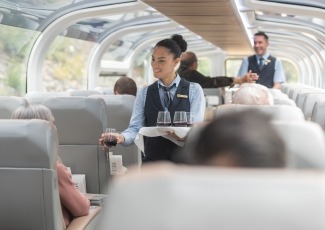 Host serving guests at their seats in GoldLeaf