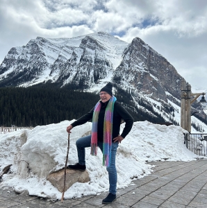 Man standing in front of mountains in the Canadian Rockies