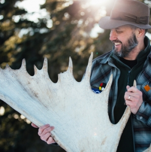 Urie displays a moose antler.