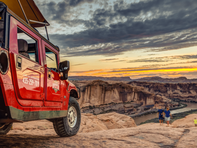 Hummer Safari on the edge of a canyon by sunset
