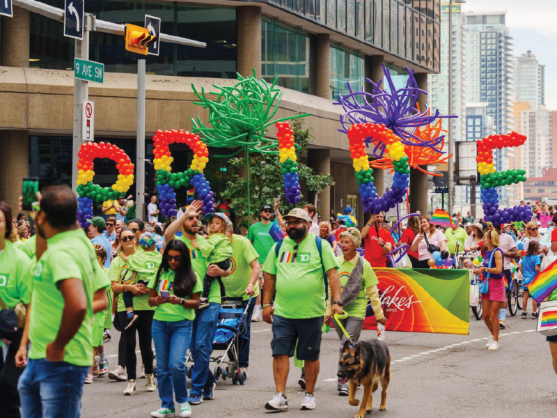 Calgary Pride Parade festival with balloons that read "pride"