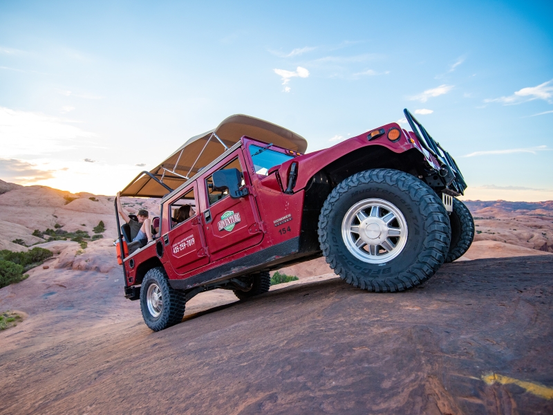 Moab Adventure Center Hummer climbing sandstone cliff