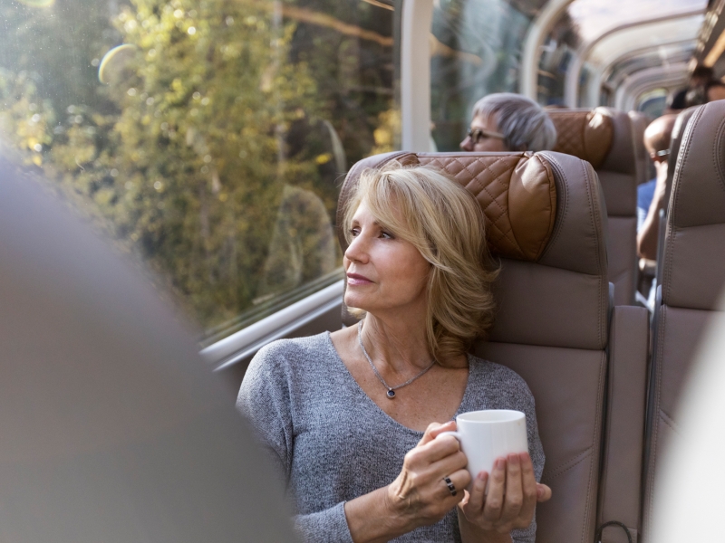 Guest sitting in GoldLeaf service enjoying a cup of coffee while looking out the window