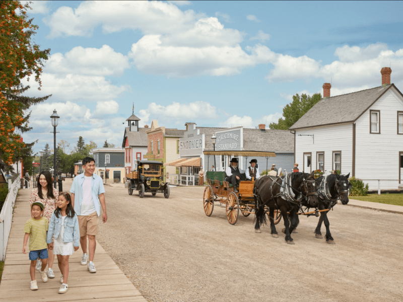 Horse and cart going through heritage park in calgary