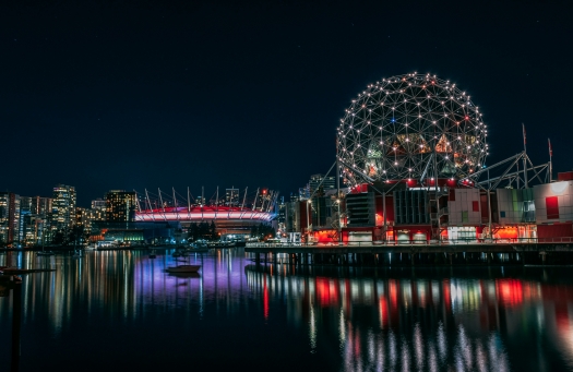 View of science world lit up at night.